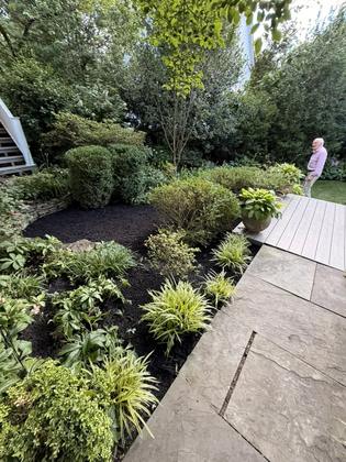 Mulch bed maintenance in a backyard in Maryland